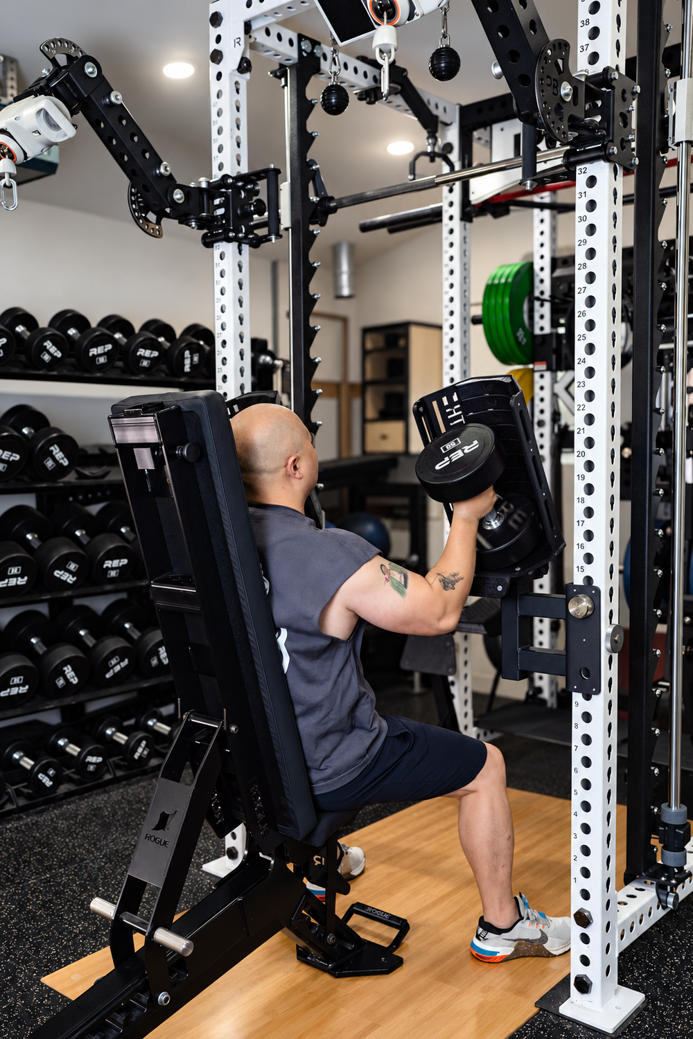 Pivot Dumbbell Spotters demonstrated during a seated press